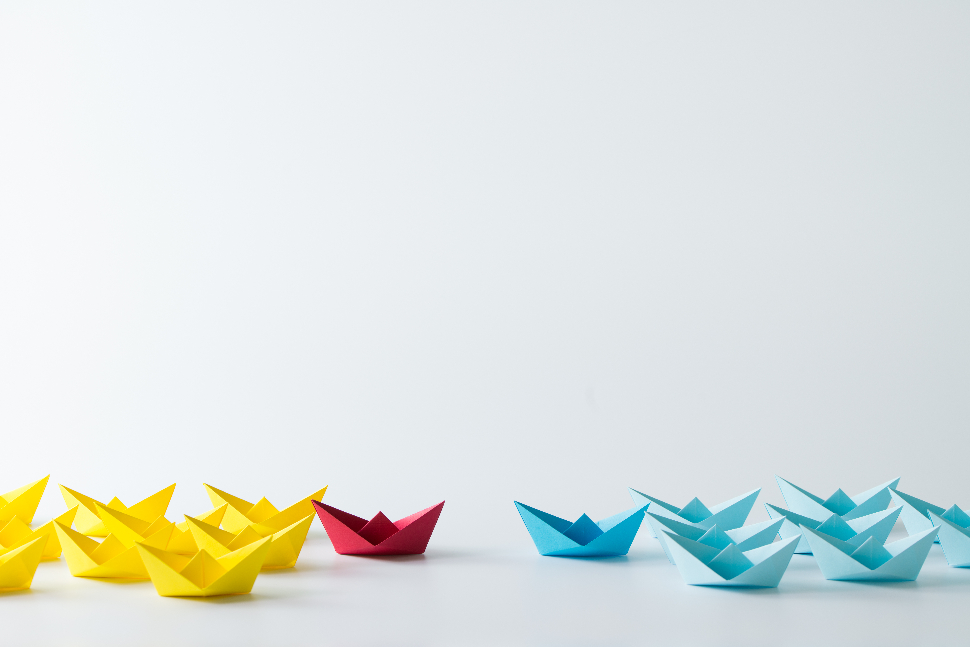 Origami ships set apart from one another as business competition metaphor
