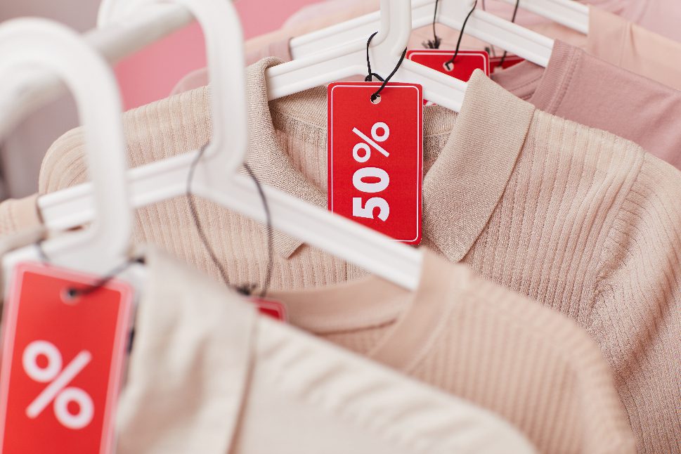 Clothing on hangers on 50% off sale for holiday season