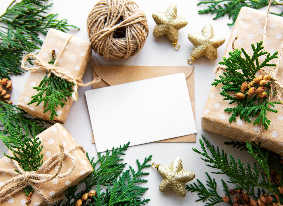 Christmas gifts and cards with evergreen branches and decorations