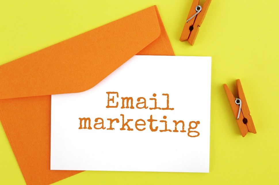 Card in envelope with 'email marketing' written on it, green and orange